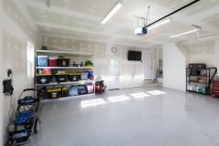 Interior of garage with drywall, lighting and TV hook up.