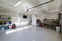 Interior of garage with drywall, lighting and TV hook up.